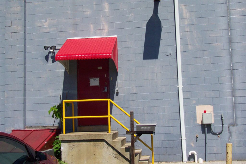 Aluminum Fairlite door hood awning on a commercial business (Glass Masters) entryway.