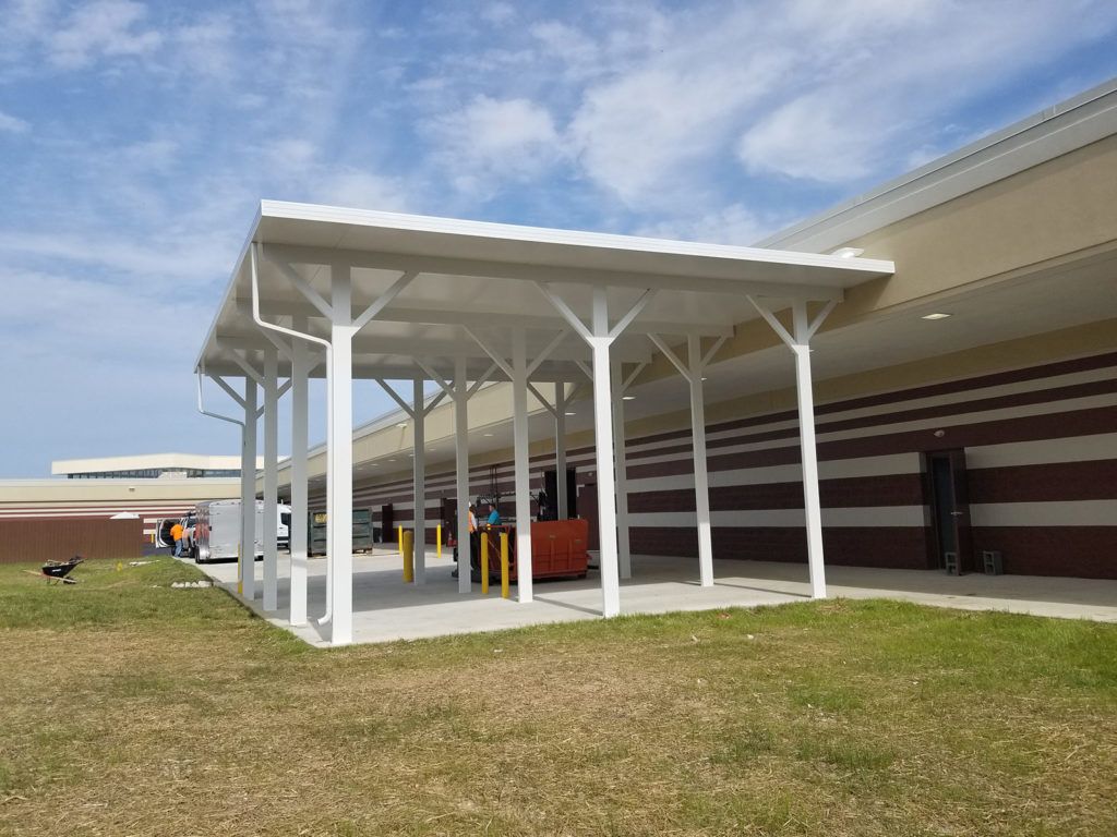Flat pan single skin patio cover roof system on a commercial warehouse