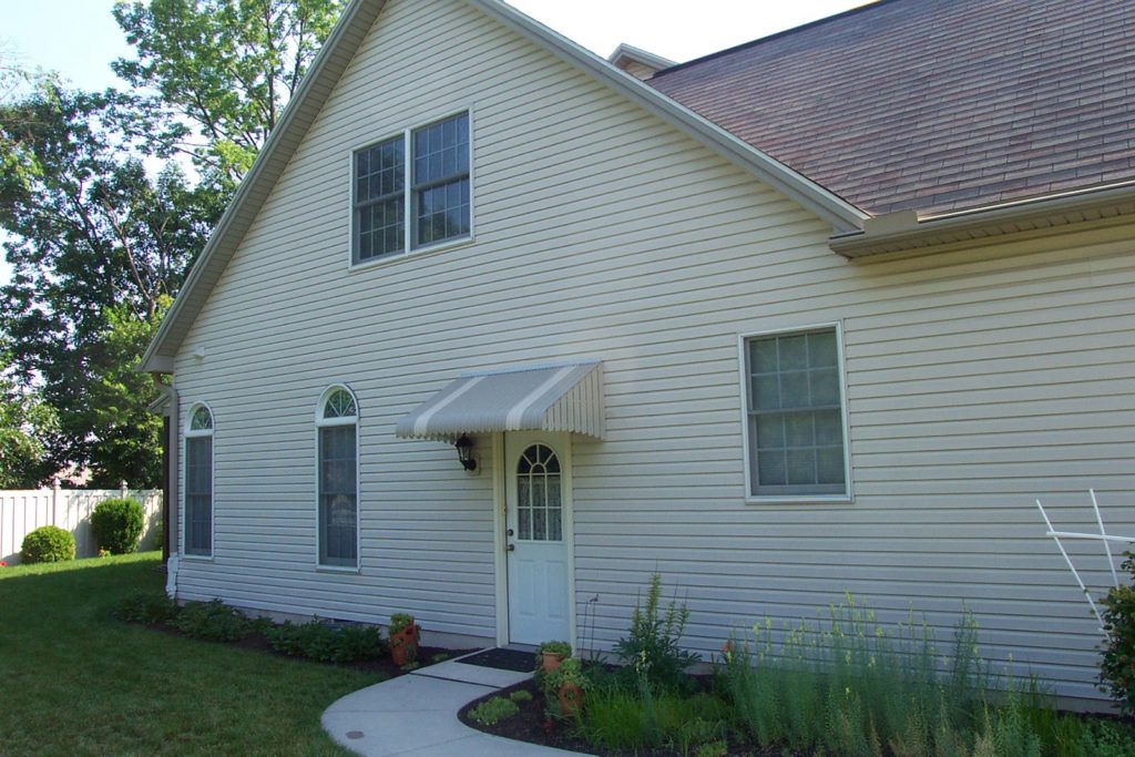 Aluminum Fairlite door hood awning on a residential home
