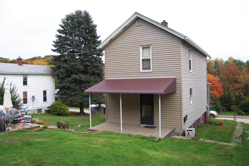 Aluminum Fairlite door hood awning on a residential home