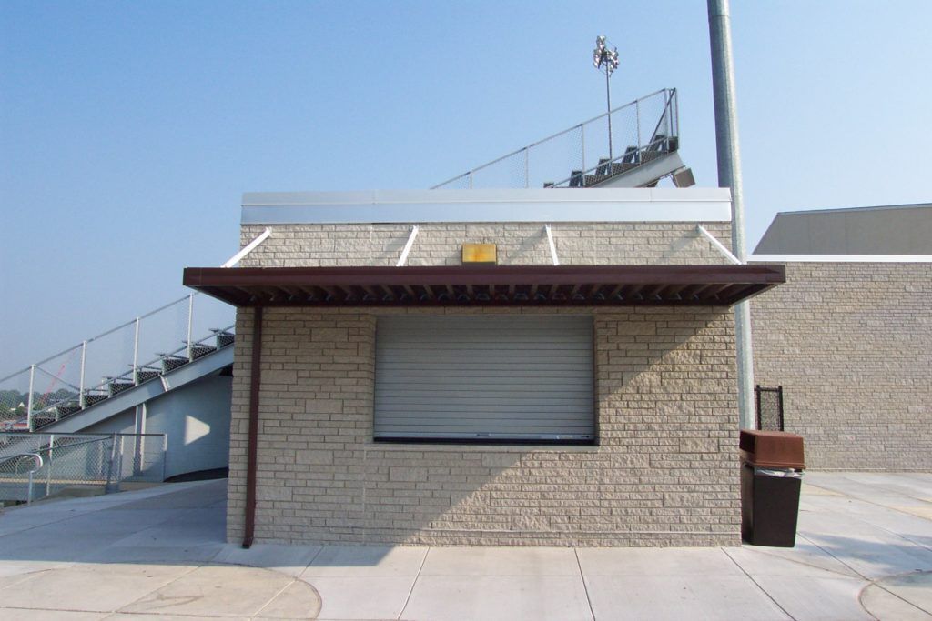 W pan single skin patio cover roof system on a stadium refreshment kiosk