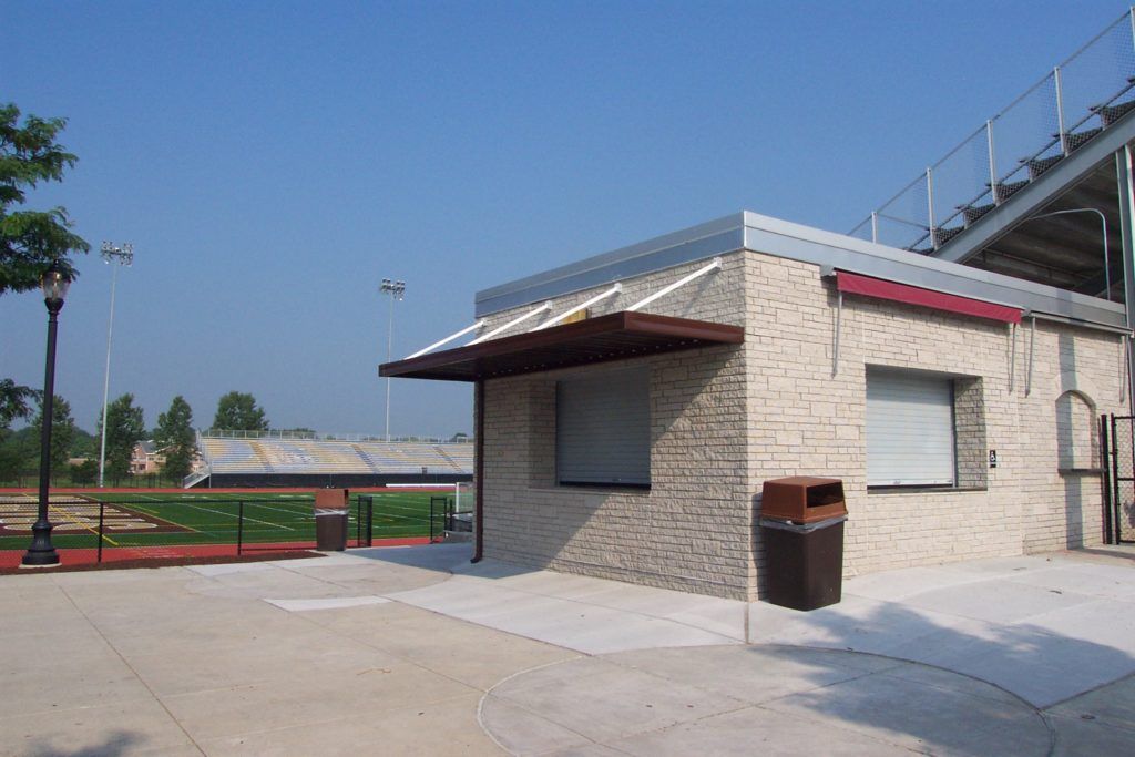 W pan single skin patio cover roof system on a stadium refreshment kiosk